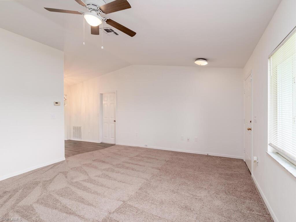 17432 Lee Road Fort Myers, FL 33967 - Photo 4 of 24 an empty room with windows and fan