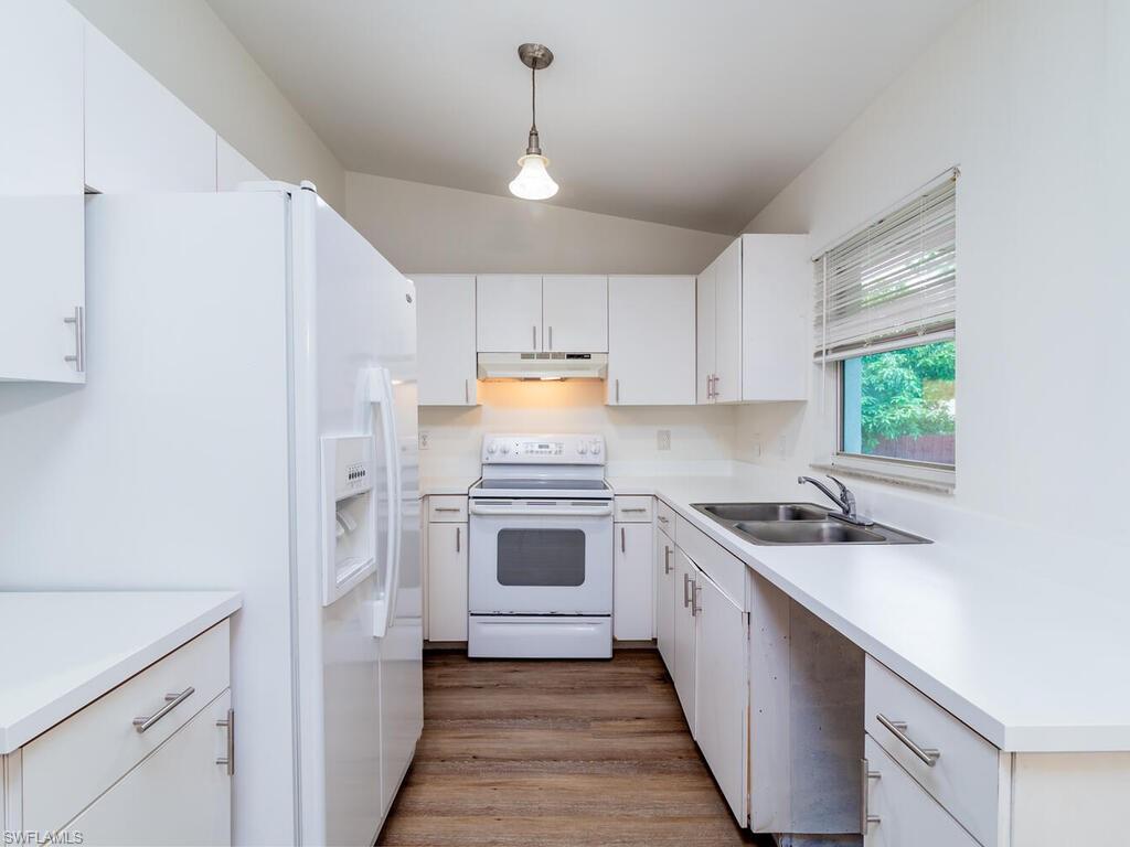 17432 Lee Road Fort Myers, FL 33967 - Photo 7 of 24 a kitchen with a sink stove and refrigerator