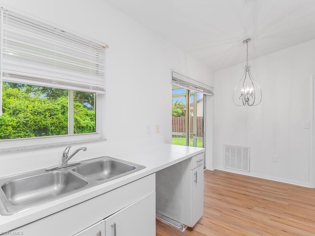 17432 Lee Road Fort Myers, FL 33967 - Photo 8 of 24 a kitchen with a sink and a large window