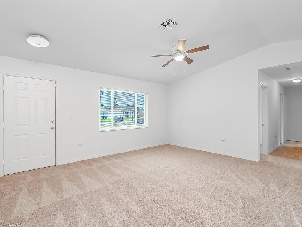 17432 Lee Road Fort Myers, FL 33967 - Photo 9 of 24 an empty room with windows and fan