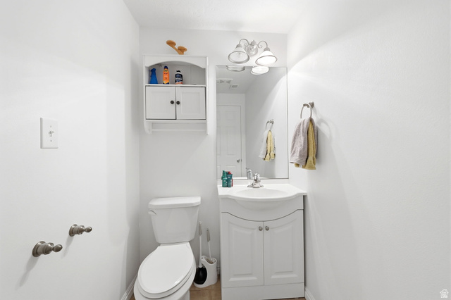1816 River Bottom Road Springville, UT 84663 - Photo 12 of 37 Compact bathroom featuring a white vanity with integrated sink, coordinating wall cabinet, and a chrome-finish light fixture