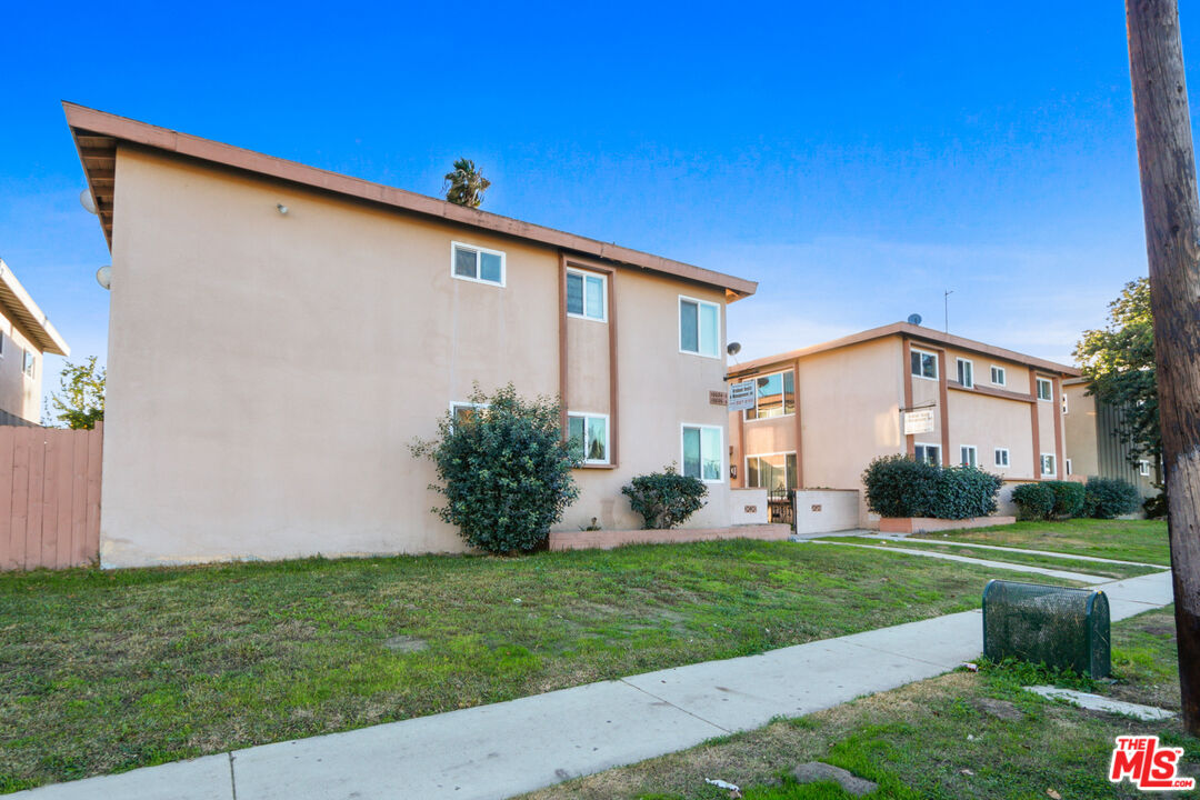 10018 Foster Road Bellflower, CA 90706 - Photo 4 of 10 a front view of a house with a yard