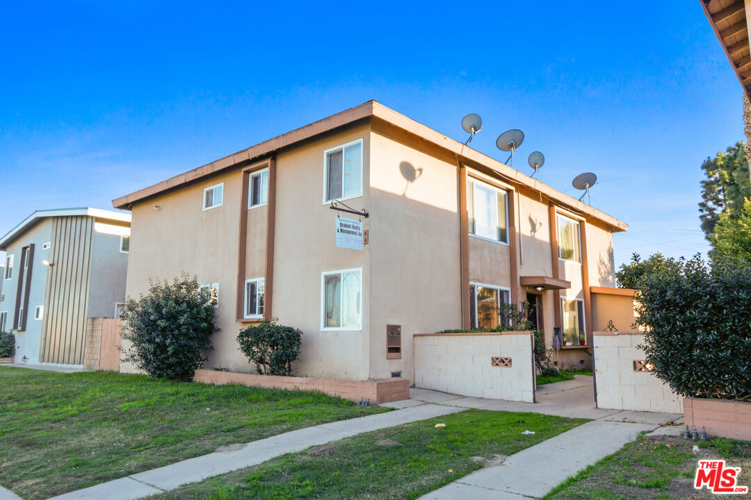10018 Foster Road Bellflower, CA 90706 - Photo 6 of 10 a front view of a house with a yard
