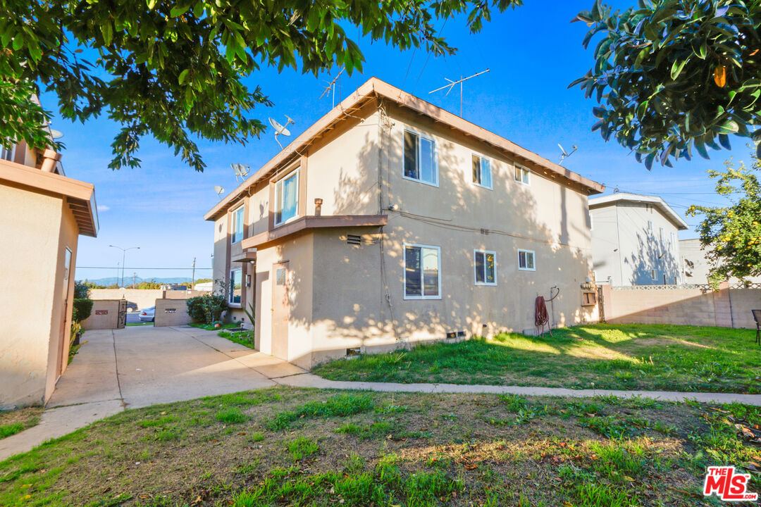 10018 Foster Road Bellflower, CA 90706 - Photo 7 of 10 a front view of a house with garden