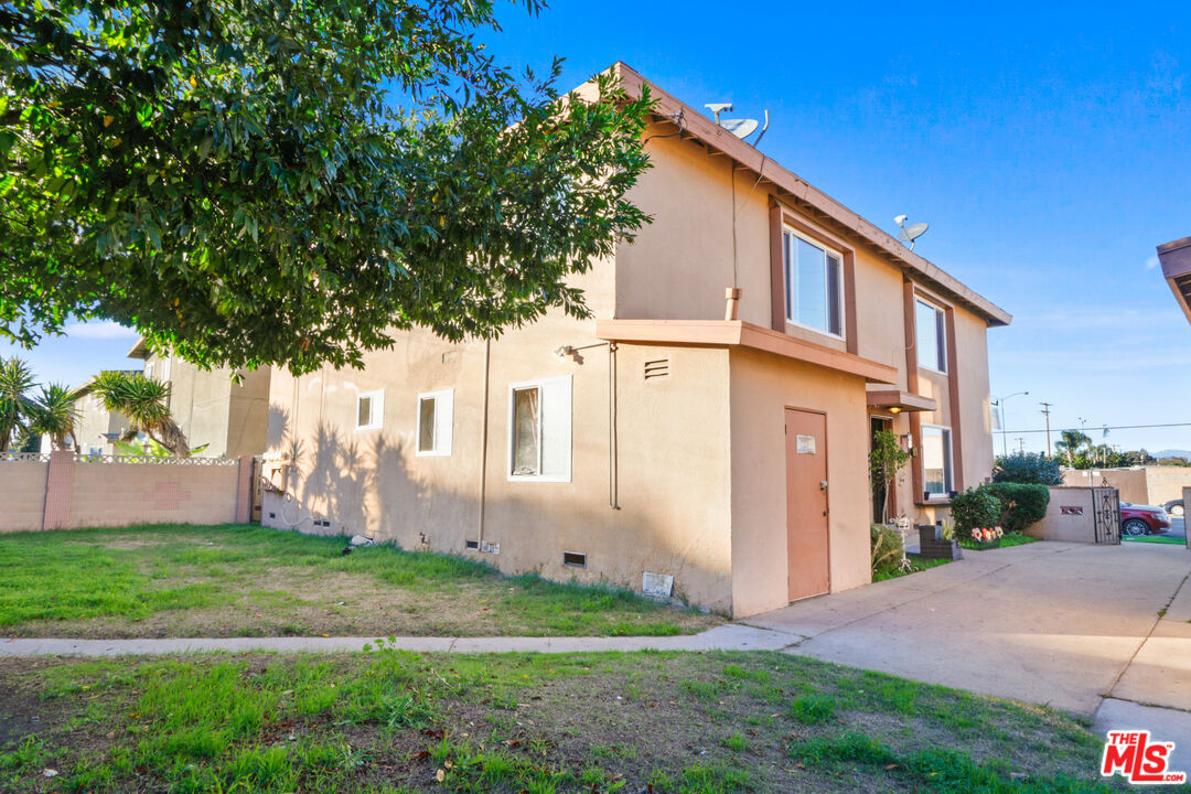 10018 Foster Road Bellflower, CA 90706 - Photo 8 of 10 a front view of a house with garden