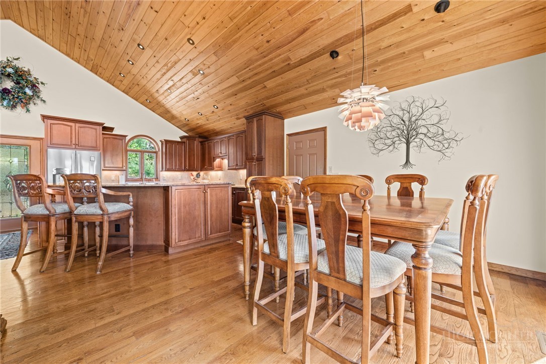331 Alpine Road Blowing Rock, NC 28605 - Photo 16 of 50 a dining room with furniture a chandelier and wooden floor