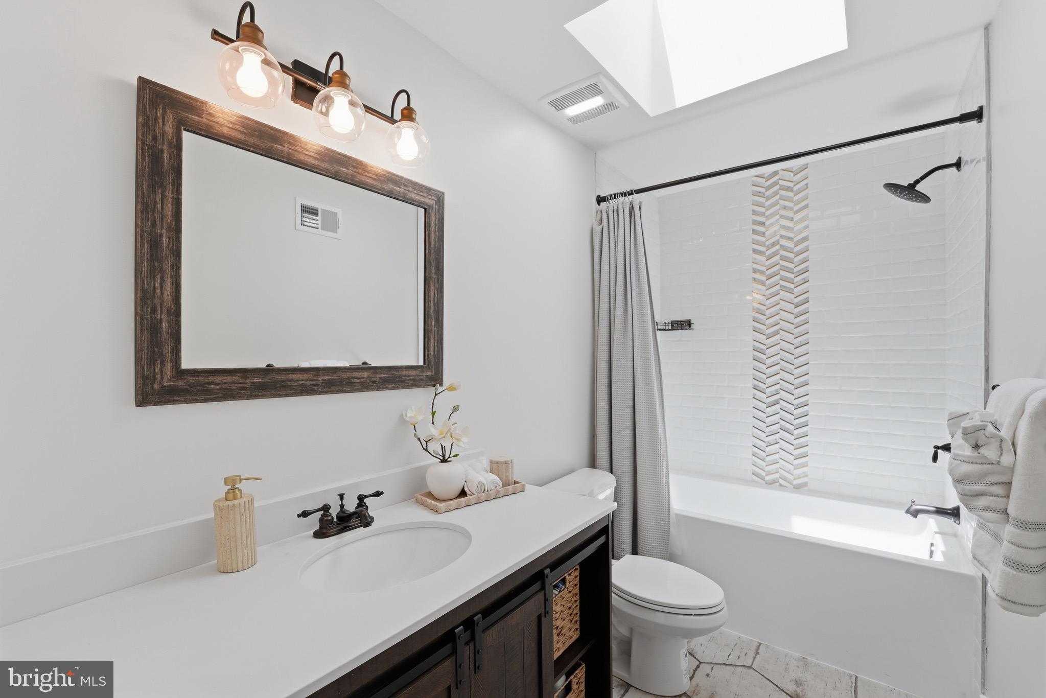 2919 Davidsonville Road Davidsonville, MD 21035 - Photo 29 of 61 a bathroom with a sink vanity mirror and toilet