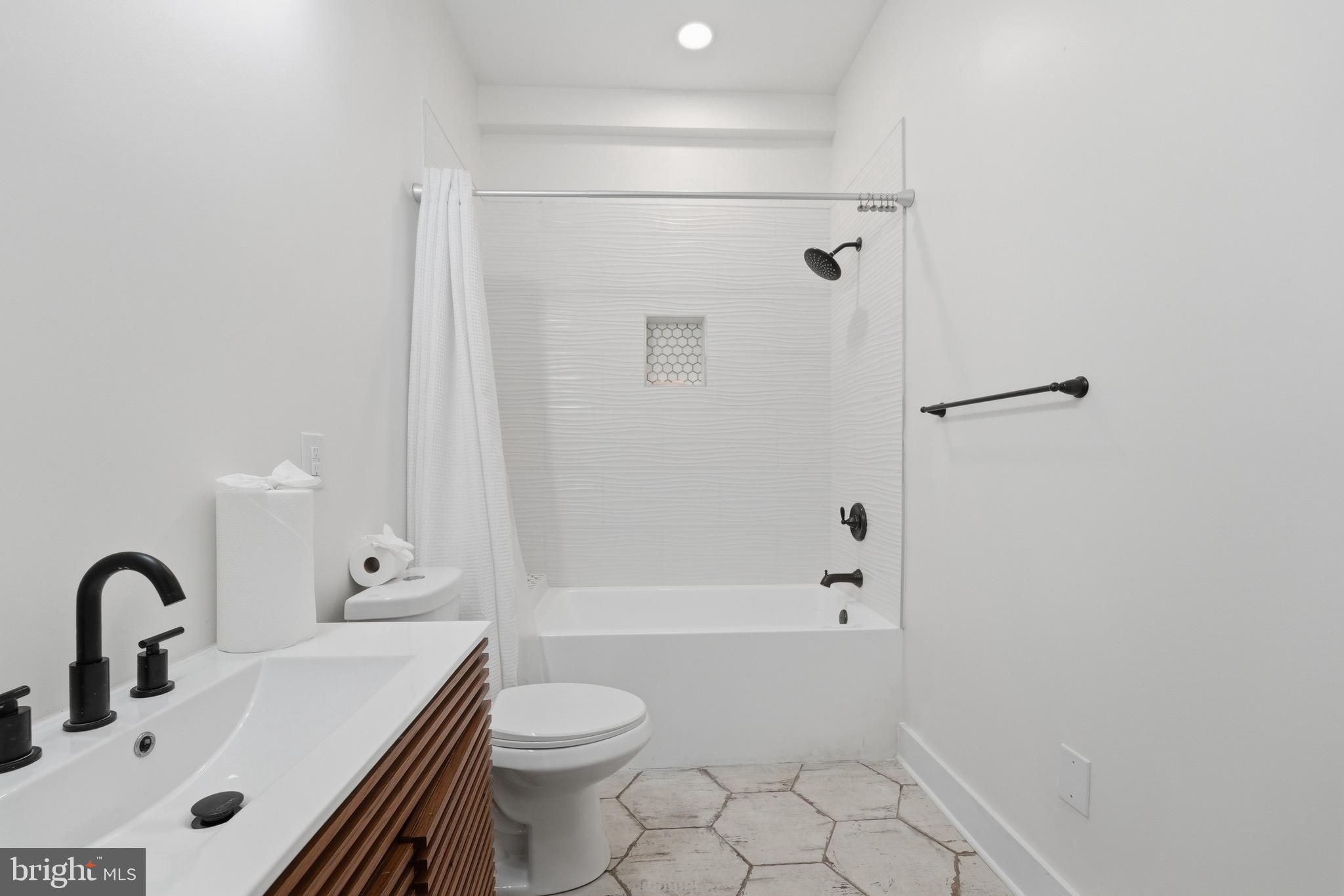 2919 Davidsonville Road Davidsonville, MD 21035 - Photo 43 of 61 a bathroom with a sink a toilet and shower
