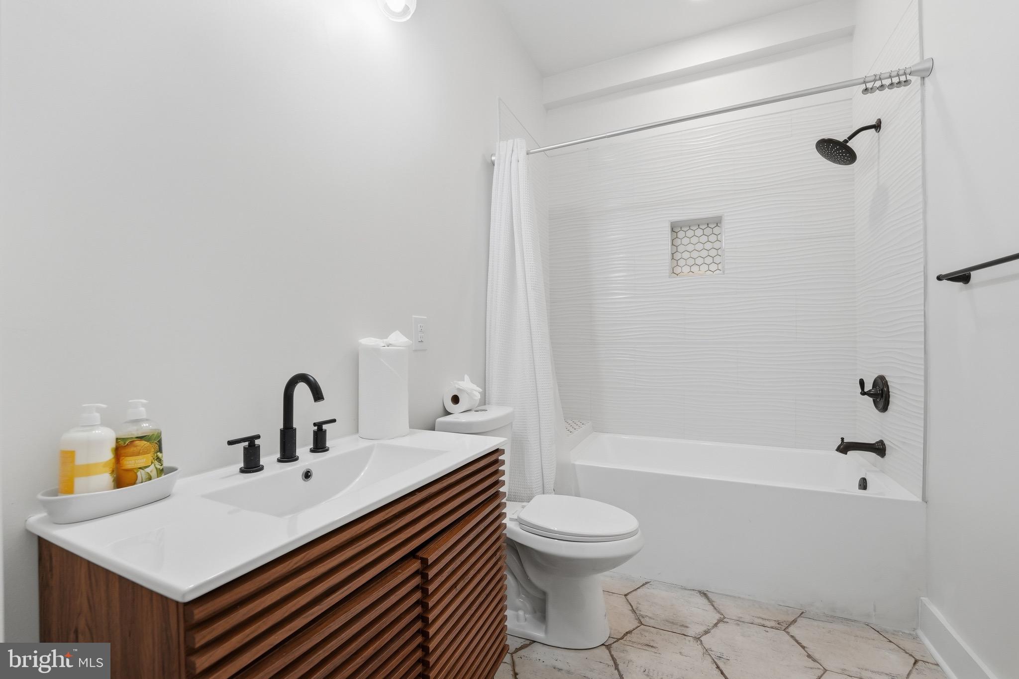 2919 Davidsonville Road Davidsonville, MD 21035 - Photo 44 of 61 a bathroom with a sink a toilet and shower