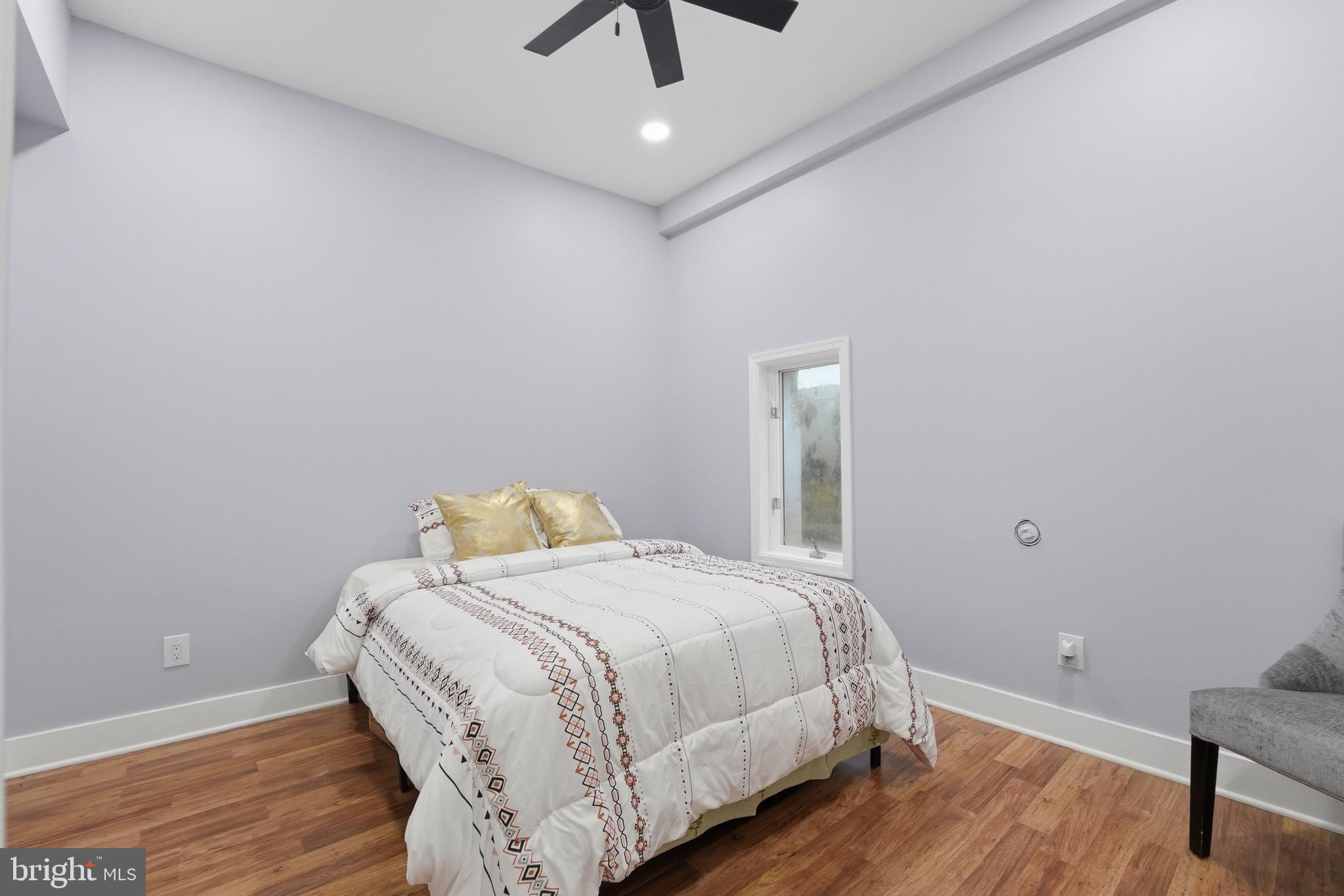 2919 Davidsonville Road Davidsonville, MD 21035 - Photo 45 of 61 a bedroom with a bed and wooden floor