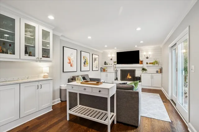 a room with furniture a flat screen tv and a fireplace