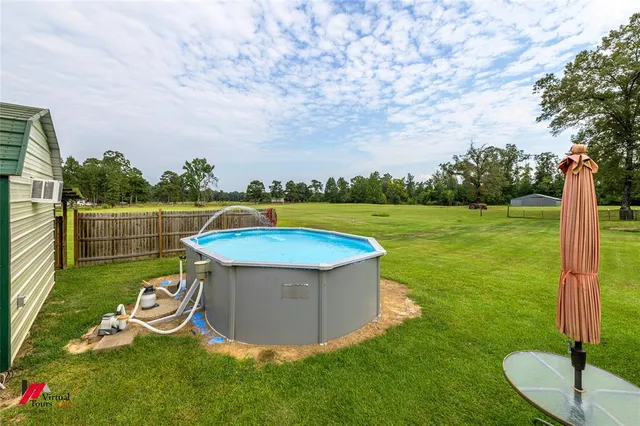 a view of a garden with a slide and a lake view
