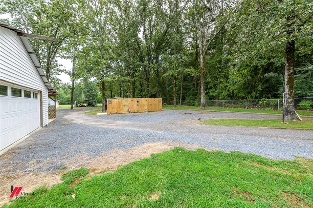 a view of a backyard with a garden and entertaining space