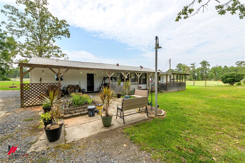 469 Foreman Road Doyline, LA 71023 - Photo 22 of 32 a view of a chair and tables in the garden