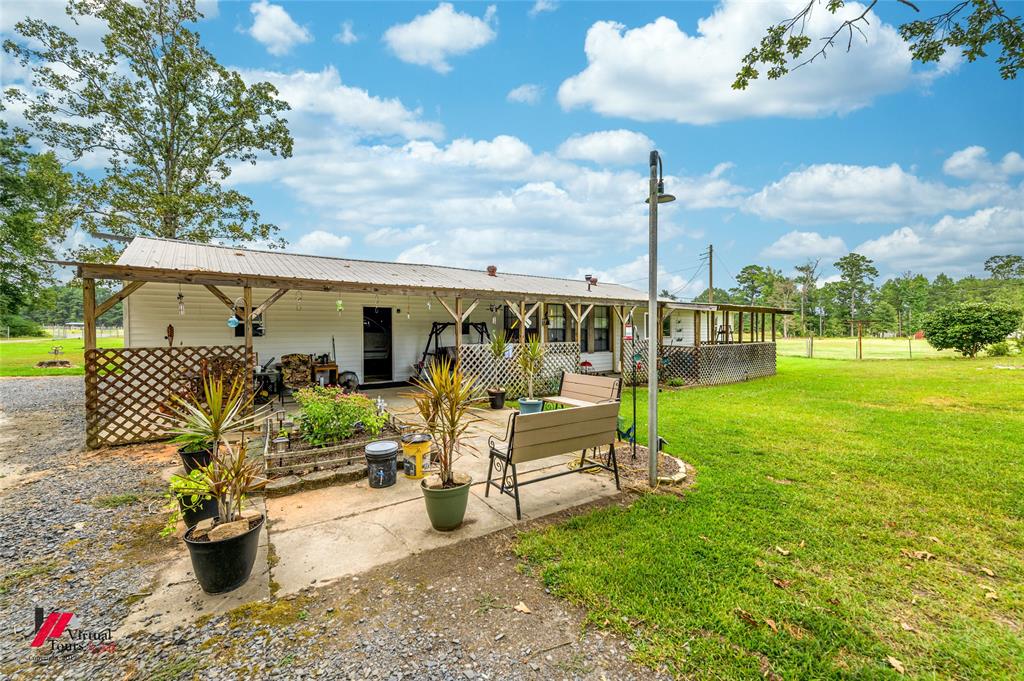 469 Foreman Road Doyline, LA 71023 - Photo 23 of 32 a view of a chair and tables in the garden