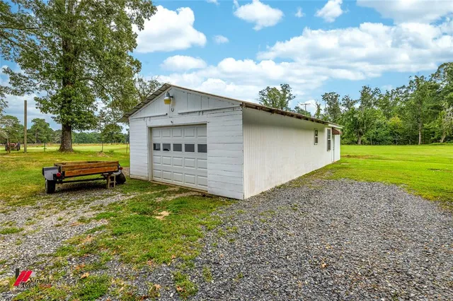 a view of a backyard with a garden and entertaining space