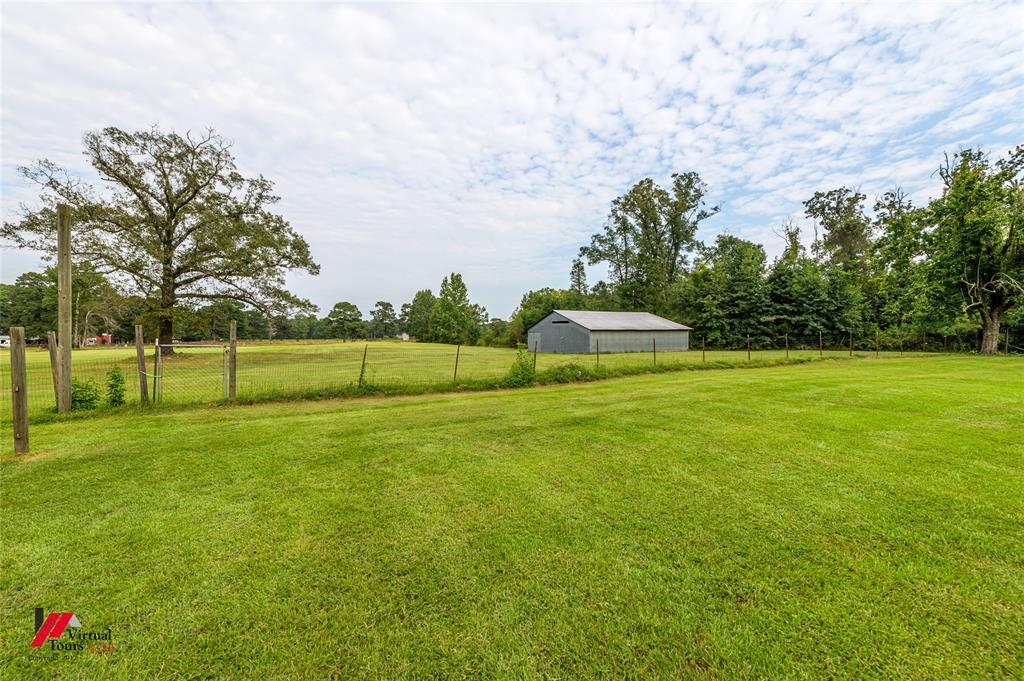 469 Foreman Road Doyline, LA 71023 - Photo 26 of 32 a view of a green field with wooden fence