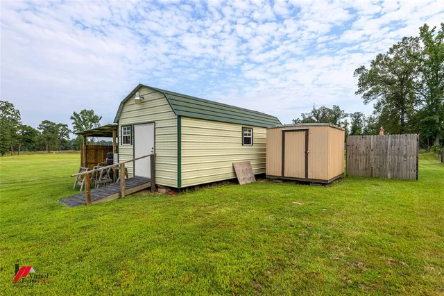 a backyard of a house with table and chairs