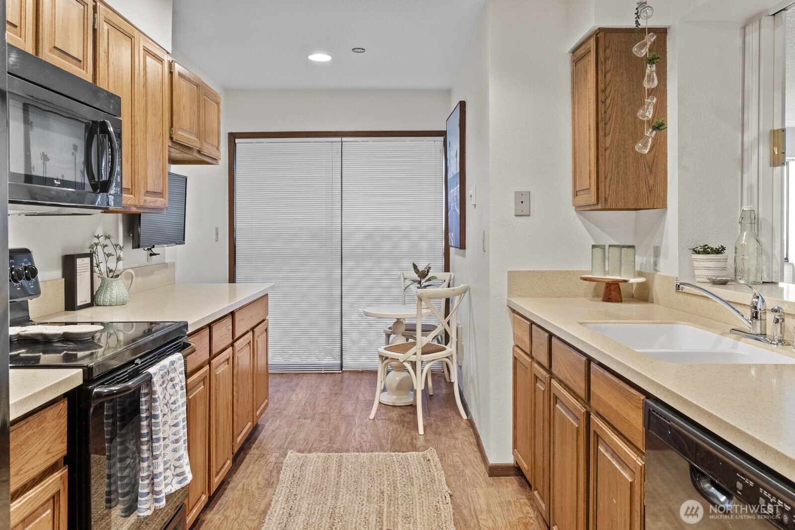 1902 Bridgeport Way West, Unit 106 University Place, WA 98466 - Photo 12 of 25 a kitchen with granite countertop a sink stove and cabinets