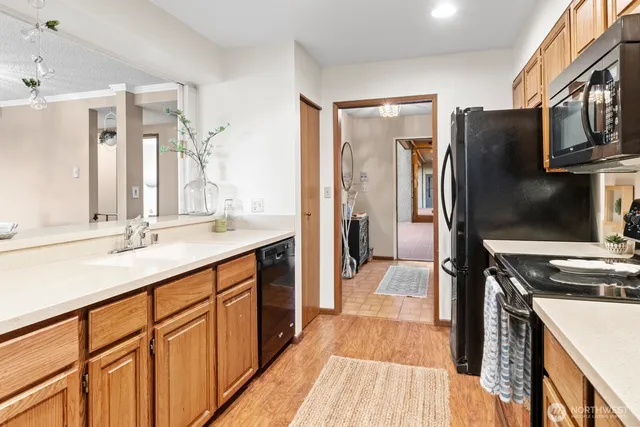 a kitchen with stainless steel appliances a sink stove and refrigerator