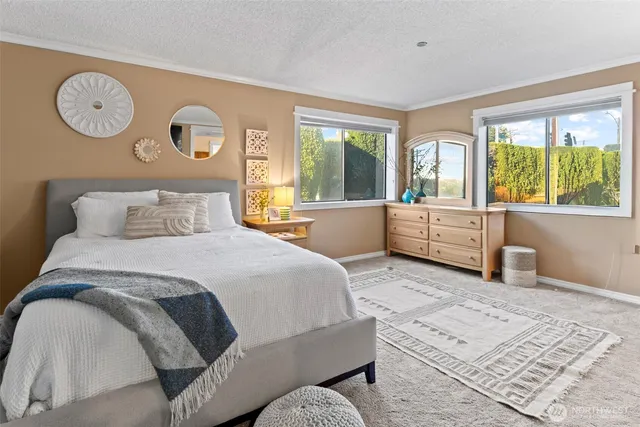 a bedroom with a large bed and a large window