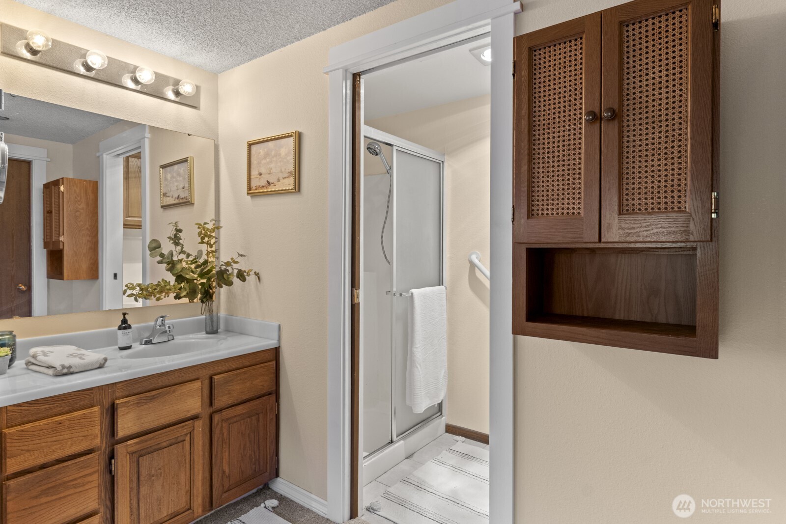 1902 Bridgeport Way West, Unit 106 University Place, WA 98466 - Photo 17 of 25 a bathroom with a sink and a mirror