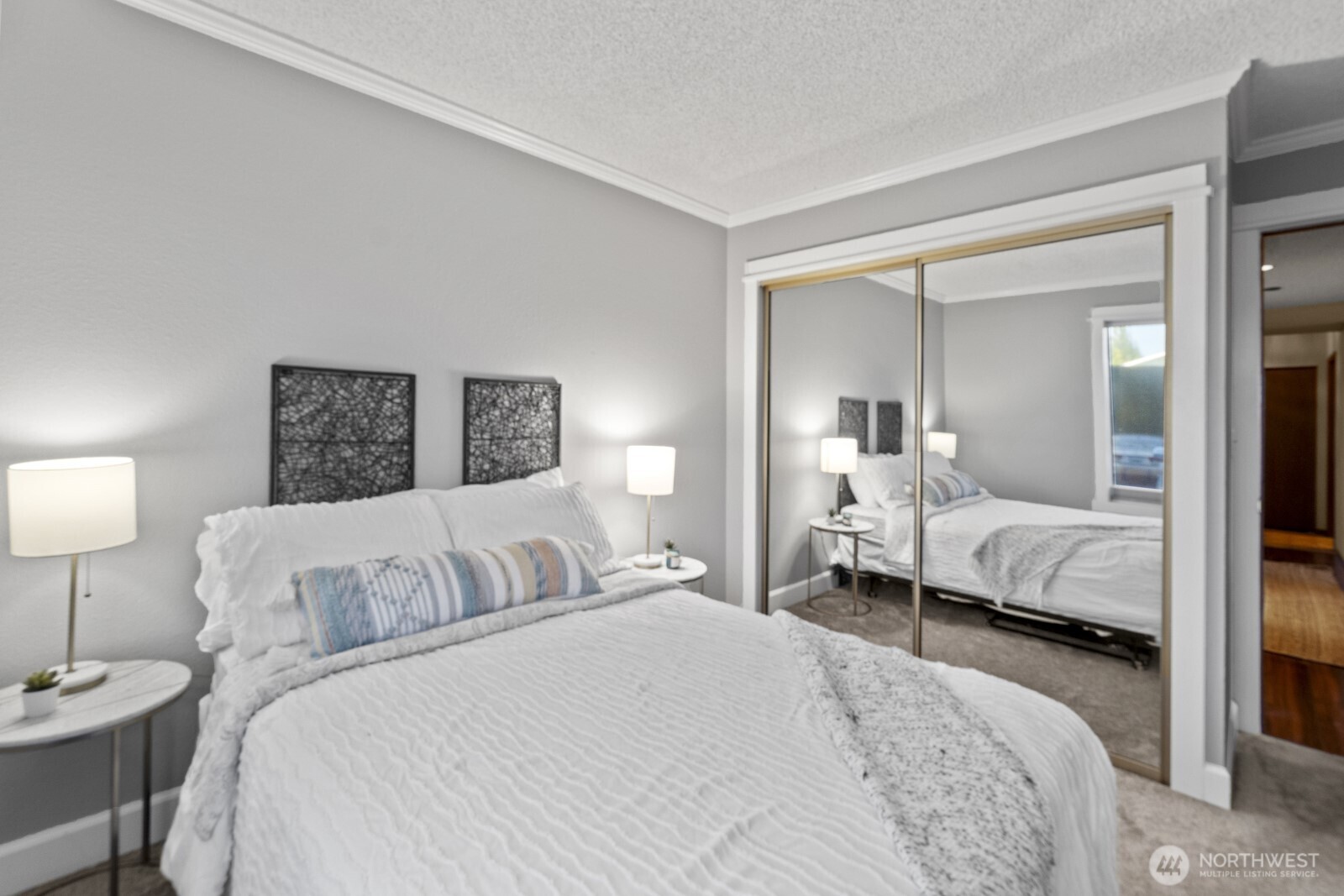 1902 Bridgeport Way West, Unit 106 University Place, WA 98466 - Photo 18 of 25 a bedroom with a bed and a large mirror