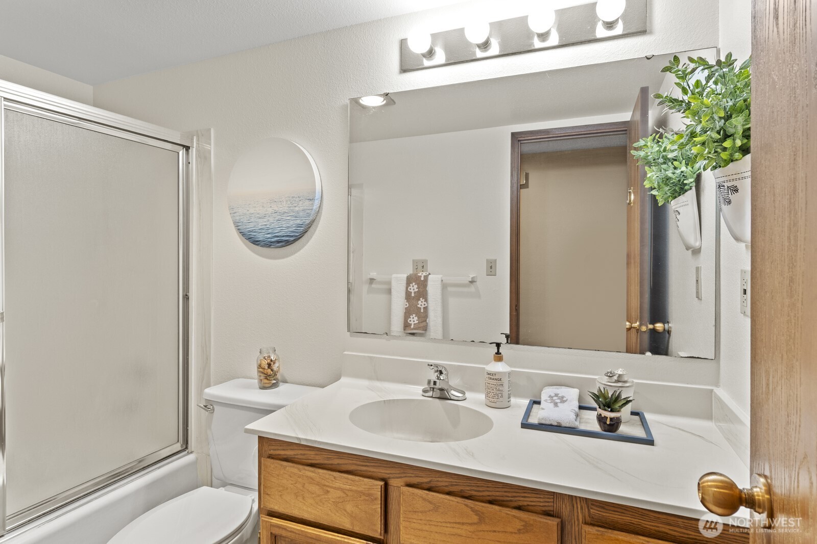 1902 Bridgeport Way West, Unit 106 University Place, WA 98466 - Photo 19 of 25 a bathroom with a sink toilet and a mirror