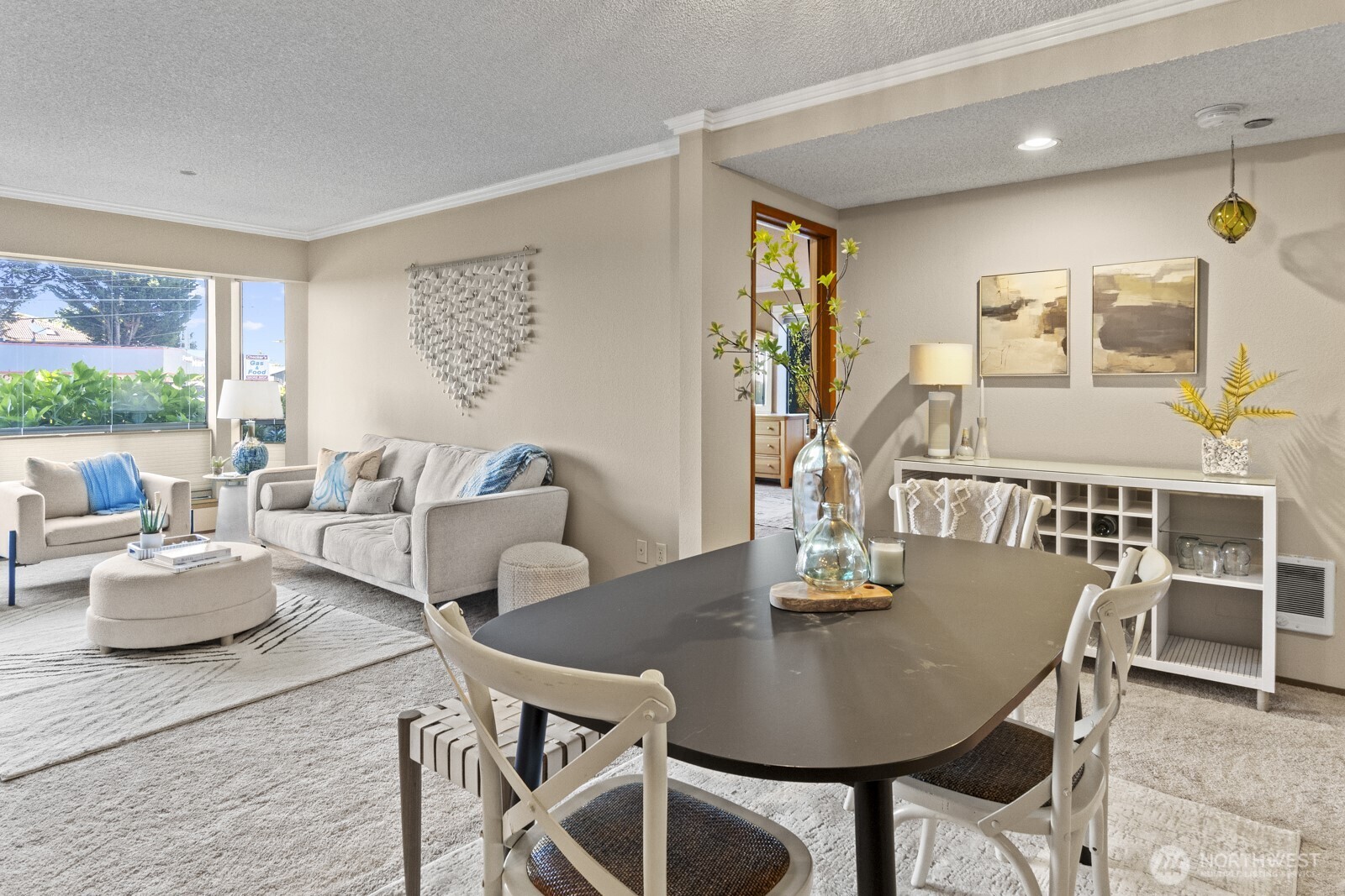1902 Bridgeport Way West, Unit 106 University Place, WA 98466 - Photo 2 of 25 a view of a dining room with furniture and wooden floor