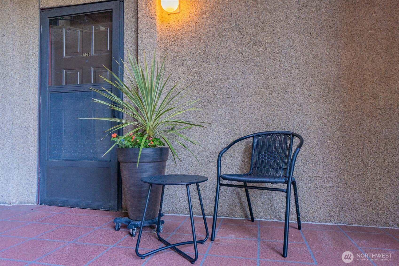 1902 Bridgeport Way West, Unit 106 University Place, WA 98466 - Photo 21 of 25 a view of a balcony with furniture and a potted plant