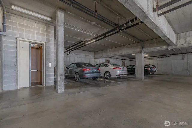 a view of parking garage with cars parked