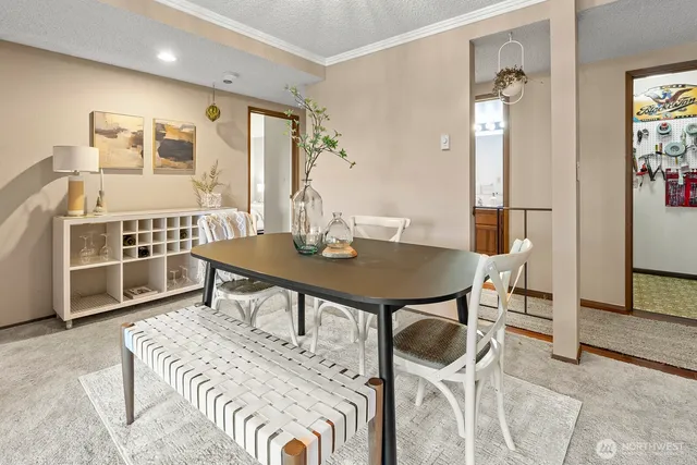 a view of a dining room with furniture and a chandelier