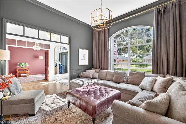 a living room with furniture and a chandelier