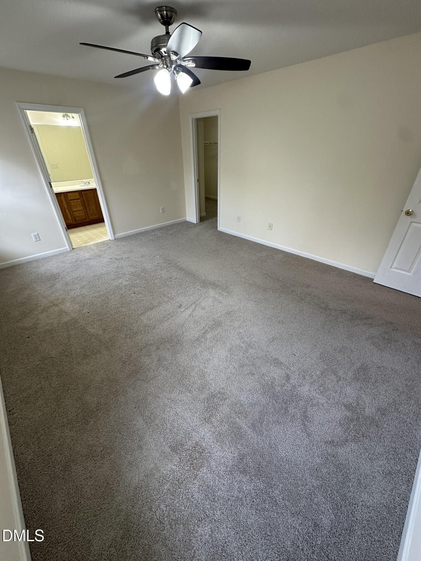 2241 Spruce Shadows Lane Raleigh, NC 27614 - Photo 11 of 18 an empty room with chandelier fan and windows