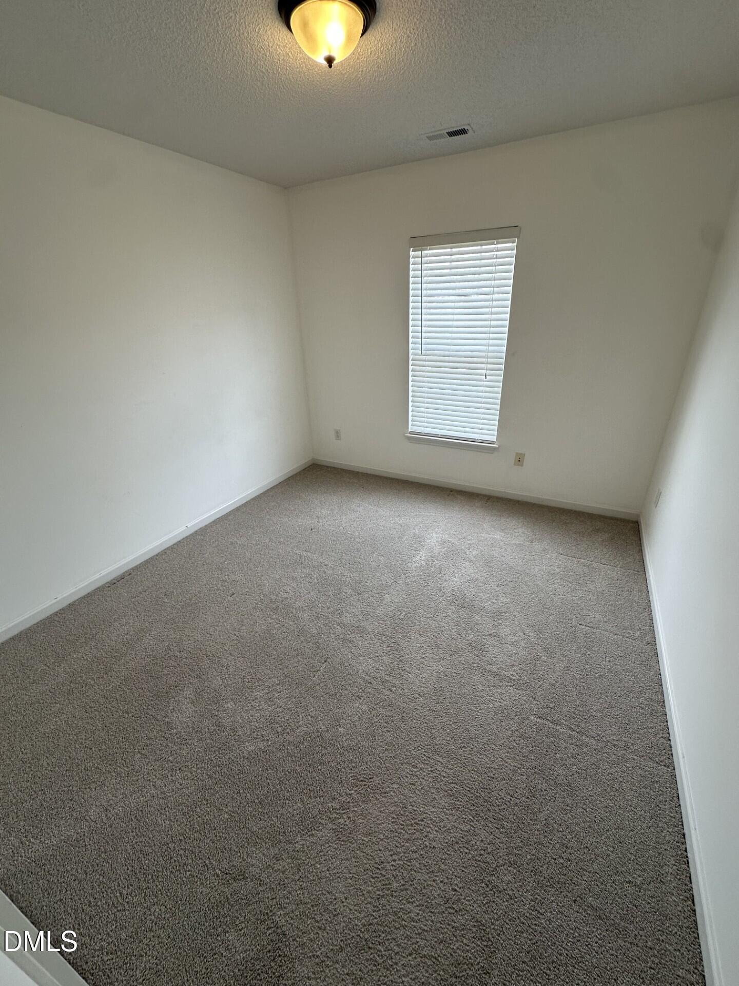 2241 Spruce Shadows Lane Raleigh, NC 27614 - Photo 17 of 18 an empty room with a window