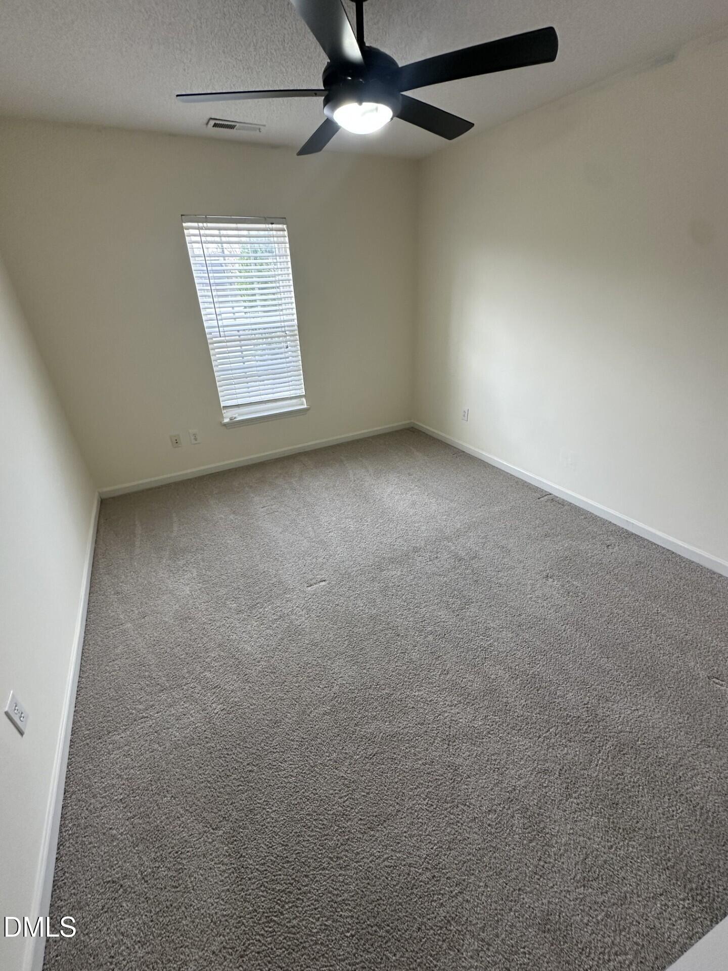 2241 Spruce Shadows Lane Raleigh, NC 27614 - Photo 18 of 18 an empty room with windows and fan