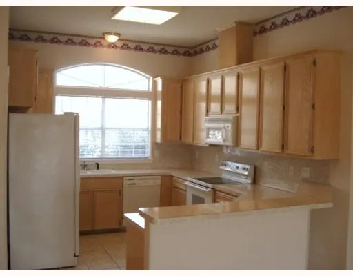 a kitchen with stainless steel appliances a sink a stove and a window