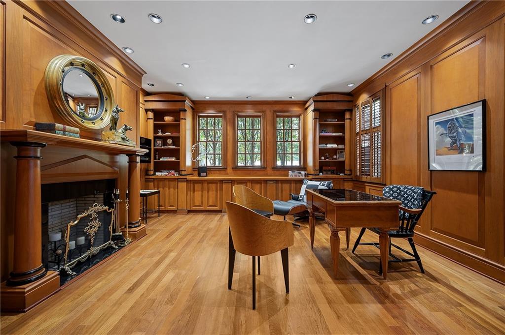 898 Persimmon Road Sewickley, PA 15143 - Photo 17 of 50 Built-in bookshelves and cabinetry are integrated seamlessly into the walls, while multiple deep-set windows bring in natural light without compromising the room’s warmth and intimacy.