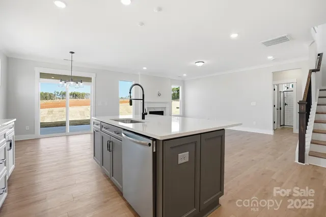 a kitchen with stainless steel appliances granite countertop a sink and stove