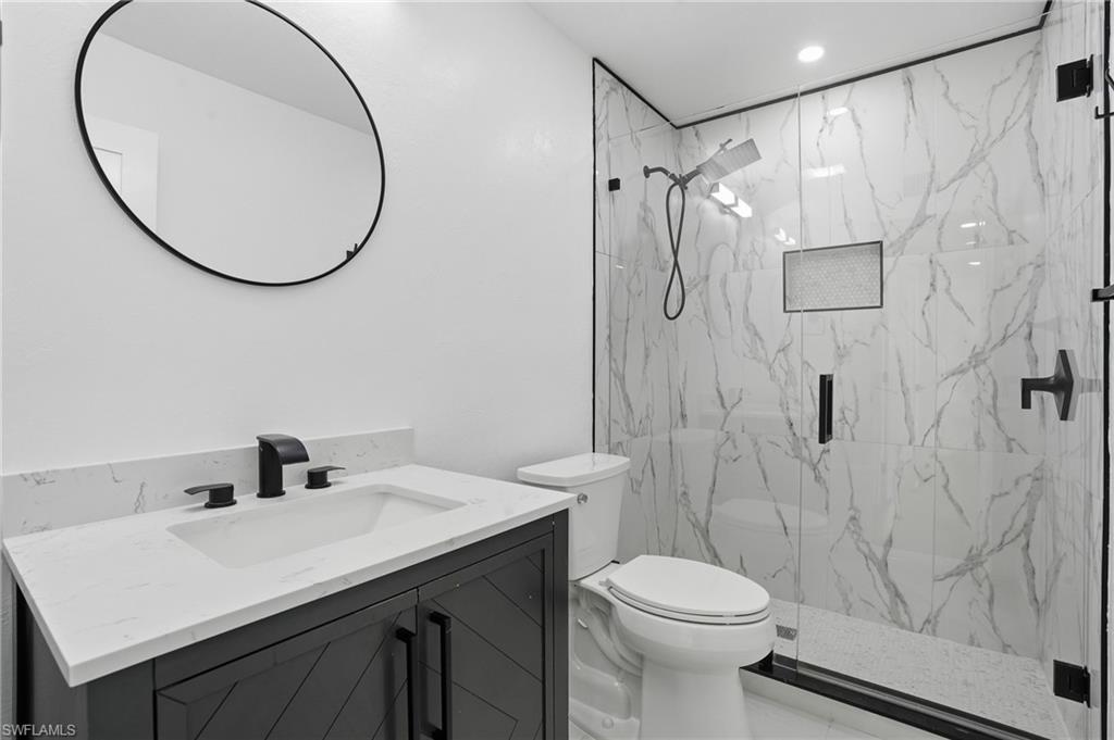 1205 Hilltop Drive Naples, FL 34103 - Photo 11 of 15 a bathroom with a sink toilet and shower