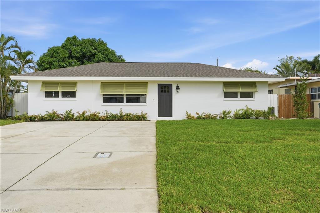 1205 Hilltop Drive Naples, FL 34103 - Photo 13 of 15 front view of house with a yard