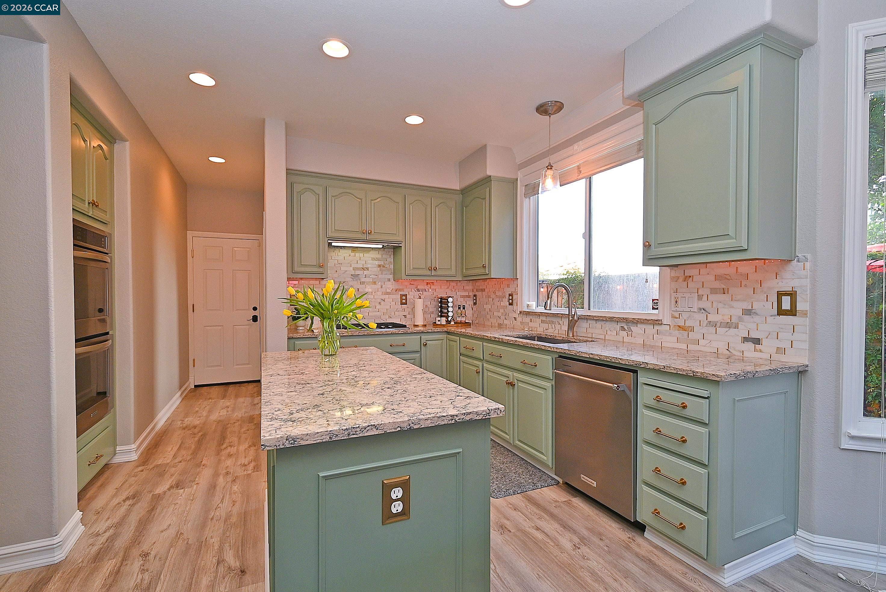 829 Deer Spring Circle Concord, CA 94521 - Photo 11 of 50 a kitchen with kitchen island granite countertop wooden cabinets and a granite counter tops