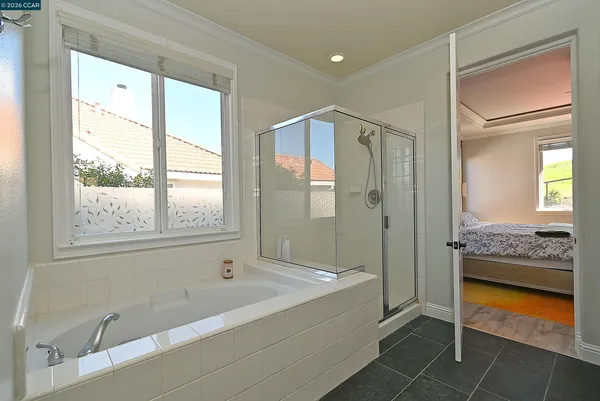 a bathroom with a tub shower and sink