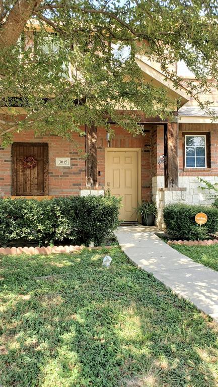 3015 Tudor Lane Irving, TX 75060 - Photo 1 of 15 a front view of a house with a yard and garage