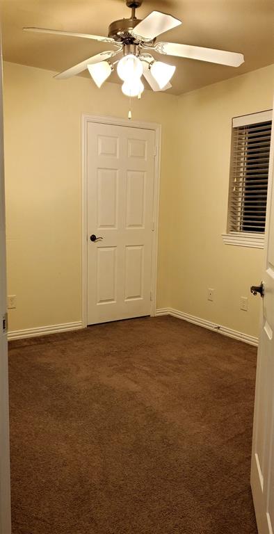 3015 Tudor Lane Irving, TX 75060 - Photo 11 of 15 a view of a room with a ceiling fan and a window