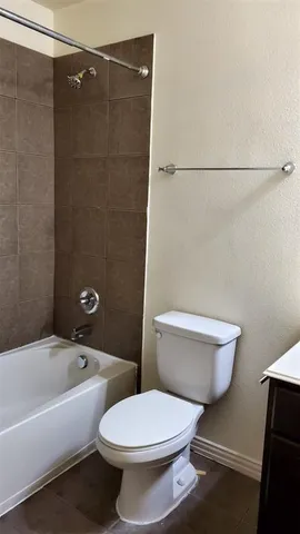 a bathroom with a toilet and a bathtub