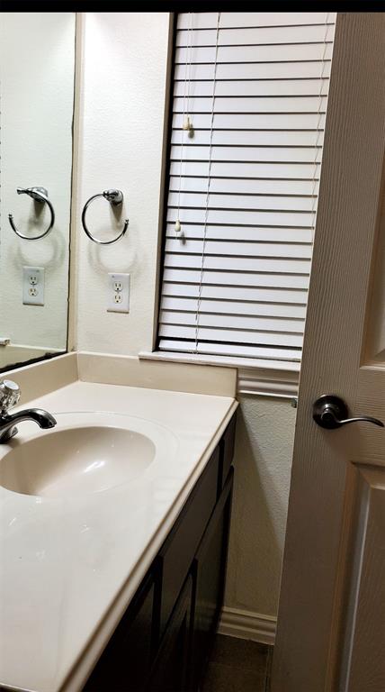 3015 Tudor Lane Irving, TX 75060 - Photo 13 of 15 a bathroom with a sink and a mirror