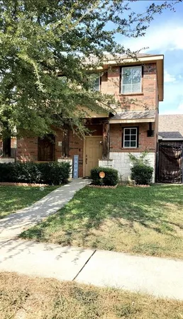 a front view of house with a garden
