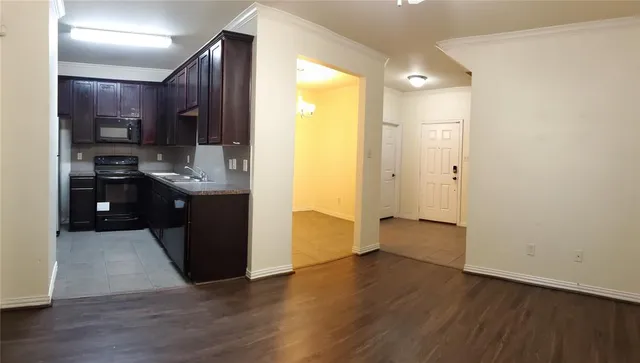 a kitchen with stainless steel appliances a refrigerator and a stove top oven