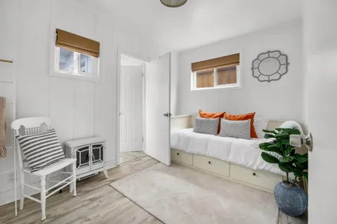 a bedroom with furniture and a potted plant